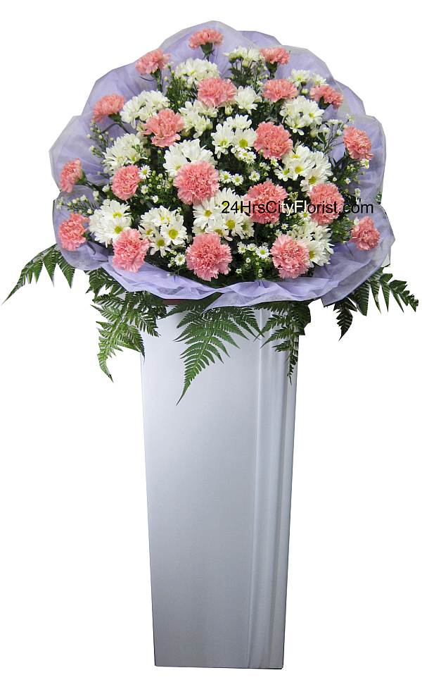 condolence flower stands with pink carnations flowers