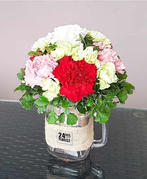 carnations arranged in mason jar