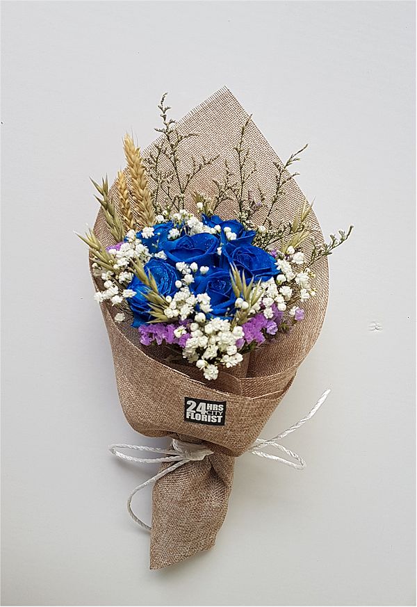 blue rose bouquet with rustic wrapping