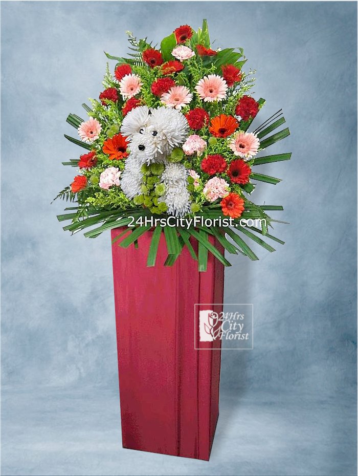 Entrepreneurial Pedigree - puppy arranged with flowers on an opening flower stand 