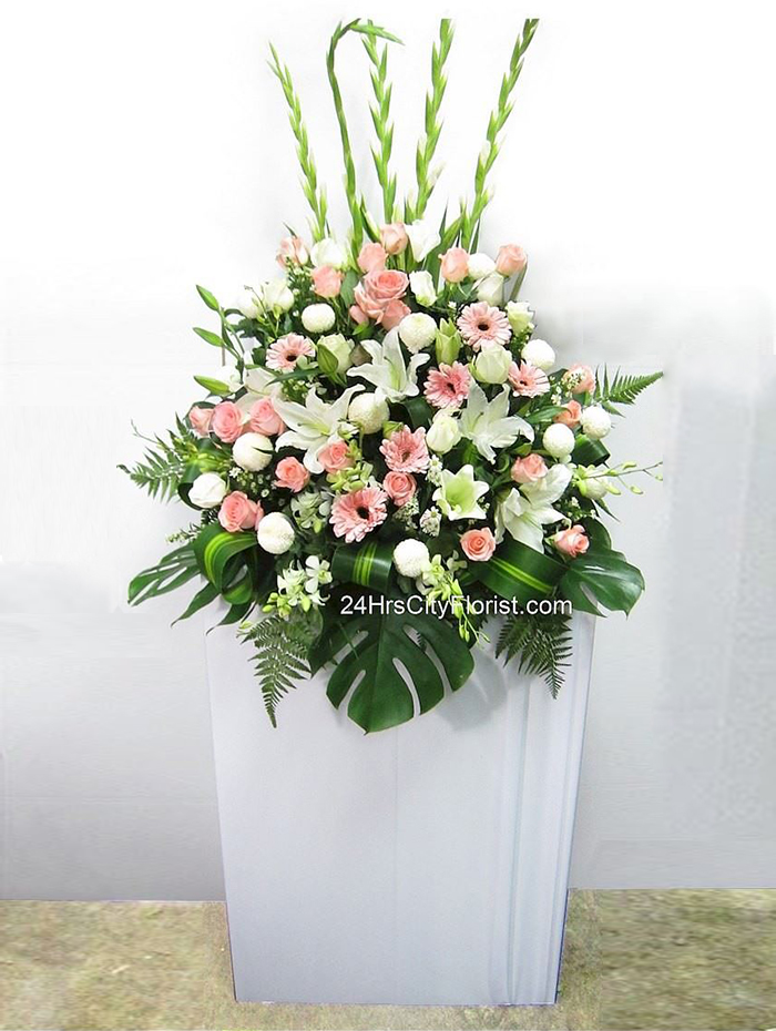 Bring Tribute -  Gladiolas, White oriental lilies, pink roses, white chrysanthemoms, poms, pink gerberas, orchids - Funeral Flowers